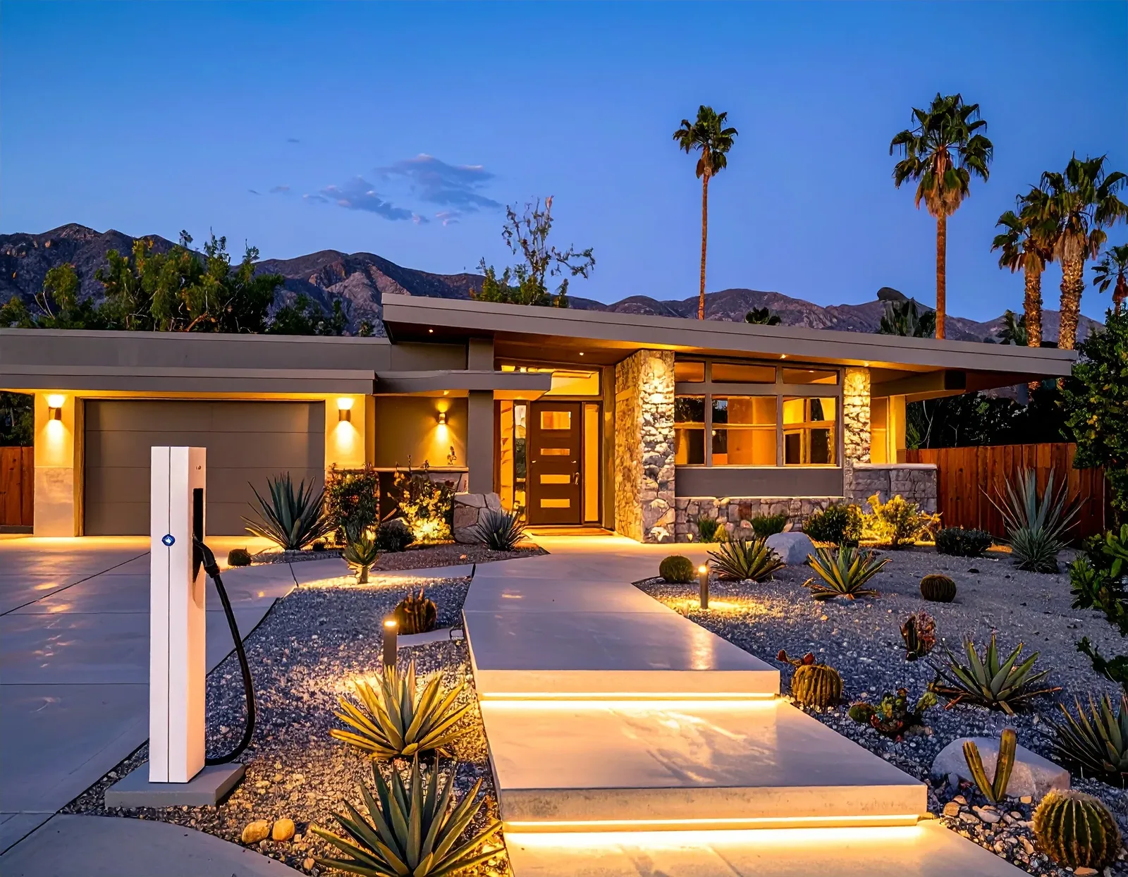 Modern desert home at dusk with facade, path, and step lighting