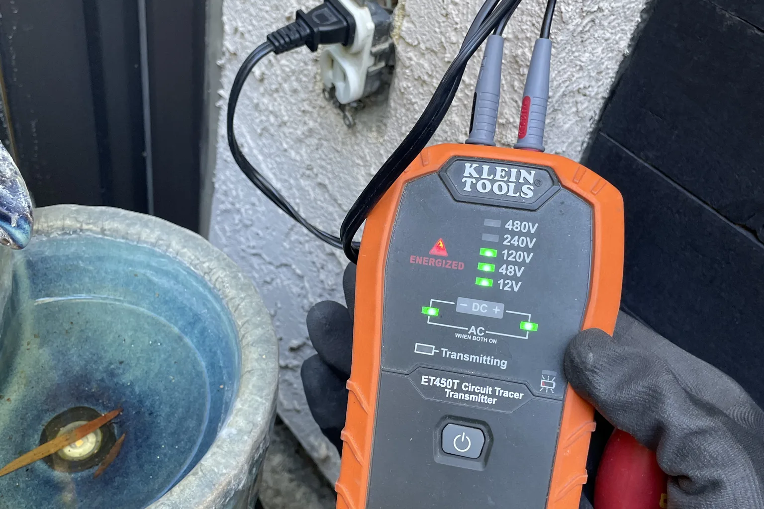 Electrician testing an energized circuit with a Klein circuit tracer